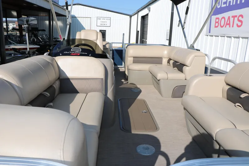 Slide: The Image of 2022 Sun Tracker Party Barge 22 RF XP3 interior with beige seating and spacious layout. - 13