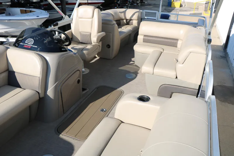 Slide: The Image of 2022 Sun Tracker Party Barge 22 RF XP3 interior with beige seating and helm. - 14