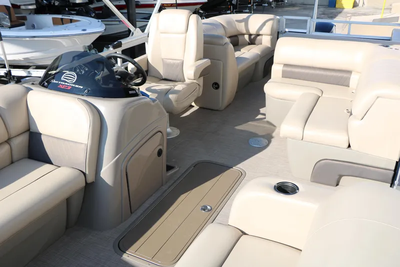 Slide: The Image of 2022 Sun Tracker Party Barge 22 RF XP3 interior with beige seating and helm. - 16