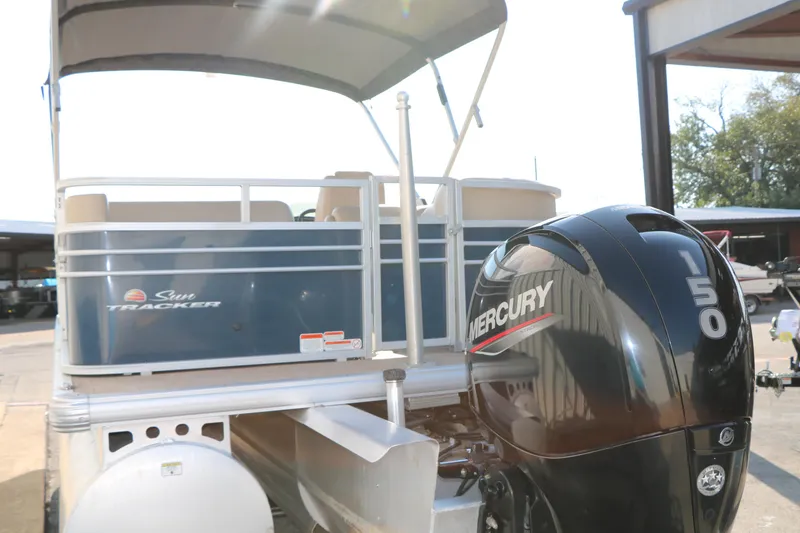 Slide: The Image of 2022 Sun Tracker Party Barge 22 RF XP3 with Mercury 150 engine, docked under a canopy. - 9