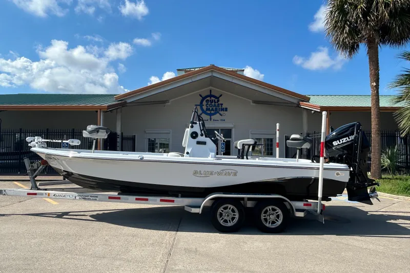 The Image of 2018 Blue Wave 2300 PureBay boat on trailer outside Gulf Coast Marine building. - 0