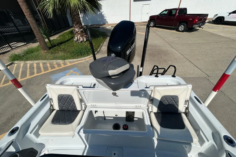 Slide: The Image of 2018 Blue Wave 2300 PureBay boat with Suzuki engine, parked near palm tree and vehicles. - 10