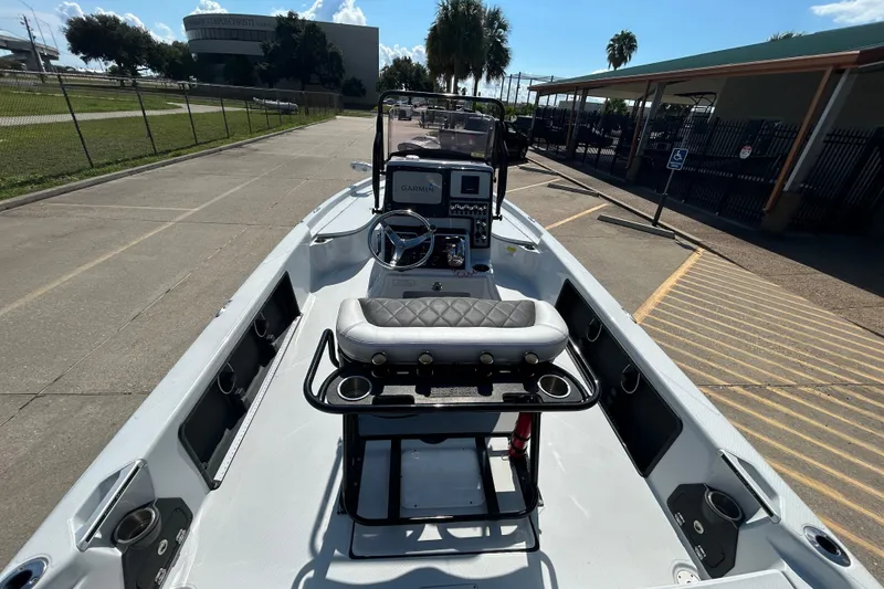 Slide: The Image of 2018 Blue Wave 2300 PureBay boat interior with Garmin navigation, parked outdoors. - 12