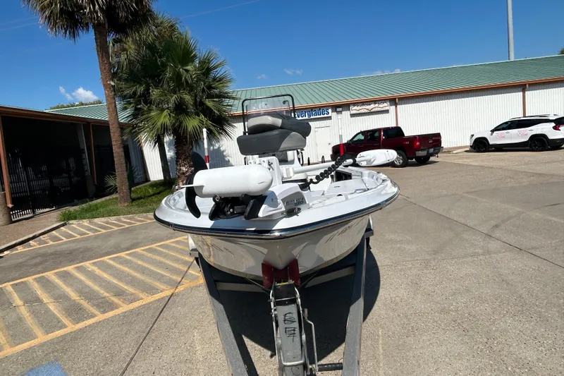 Slide: The Image of 2018 Blue Wave 2300 PureBay boat on trailer in parking lot, palm tree nearby. - 2