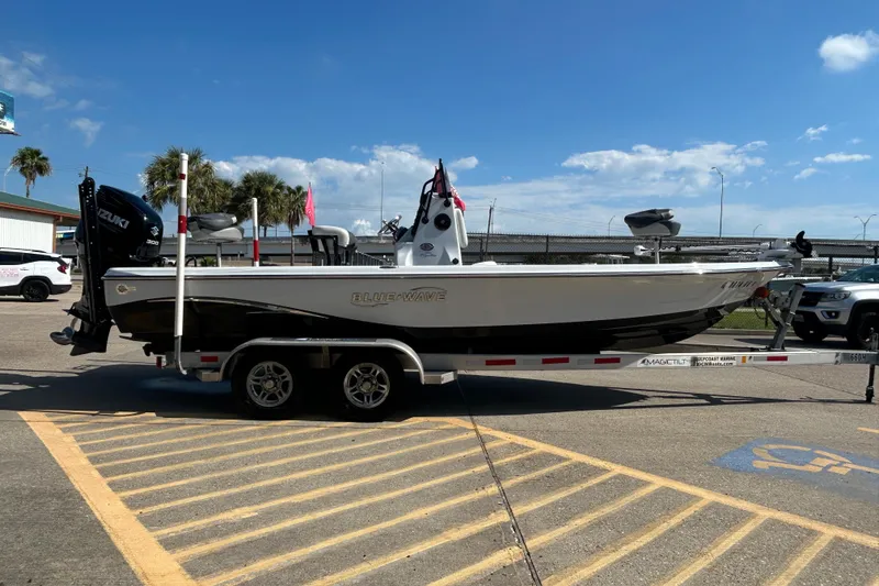 Slide: The Image of 2018 Blue Wave 2300 PureBay boat on trailer, parked in sunny lot. - 4