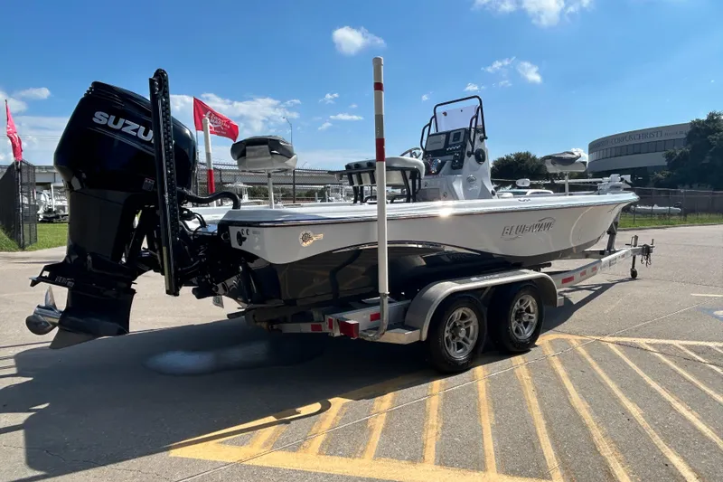 Slide: The Image of 2018 Blue Wave 2300 PureBay boat on trailer with Suzuki outboard motor. - 7