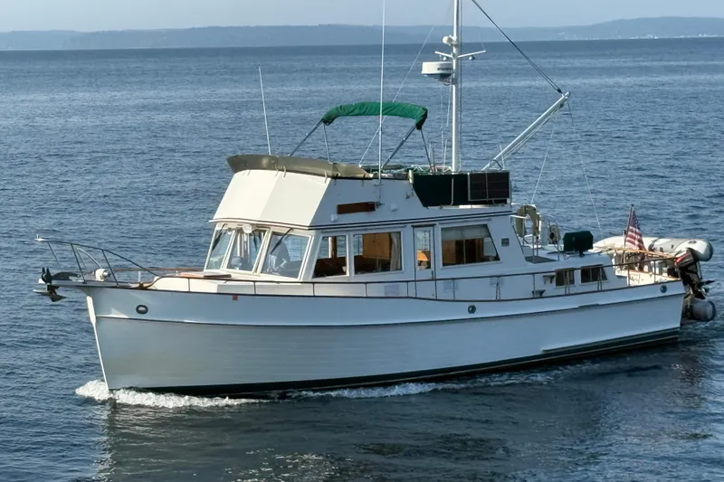 The Image of 1988 Grand Banks Heritage CL yacht cruising on open water. - 0