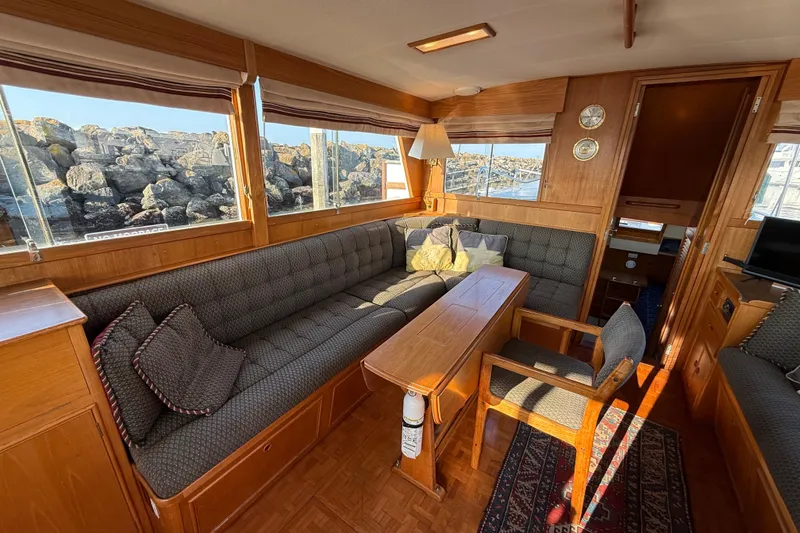 Slide: The Image of Luxurious 1988 Grand Banks Heritage CL yacht interior with elegant wood furnishings and comfortable seating. - 10