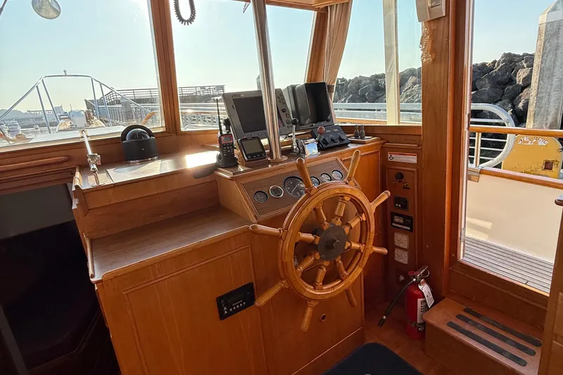 Slide: The Image of 1988 Grand Banks Heritage CL helm with wooden wheel and navigation equipment. - 12
