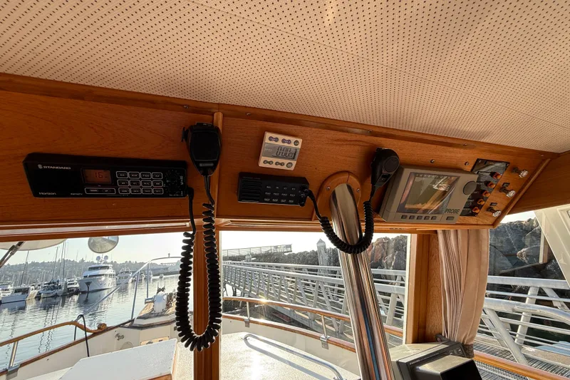 Slide: The Image of 1988 Grand Banks Heritage CL boat interior with navigation equipment and marina view. - 16