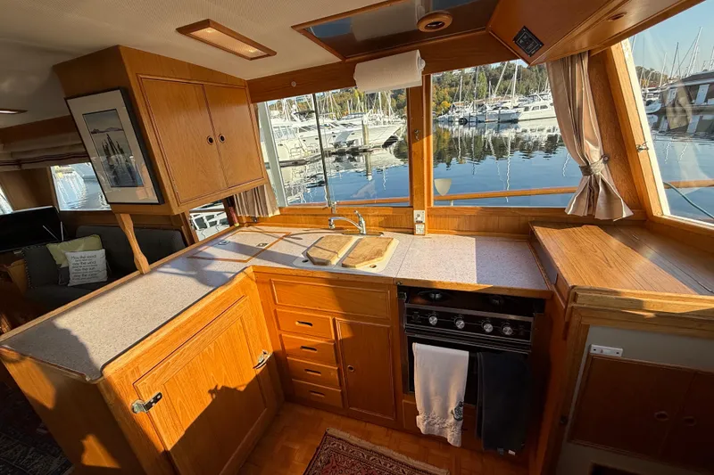 Slide: The Image of 1988 Grand Banks Heritage CL yacht kitchen with wood cabinetry and marina view. - 17