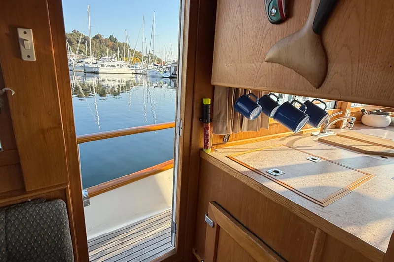 Slide: The Image of Interior view of 1988 Grand Banks Heritage CL yacht with marina in background. - 19