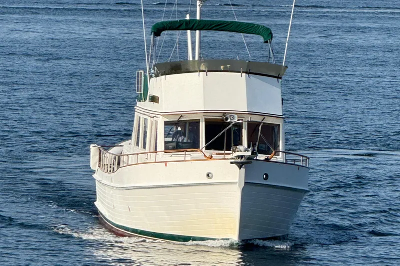 Slide: The Image of 1988 Grand Banks Heritage CL yacht cruising on open water. - 2