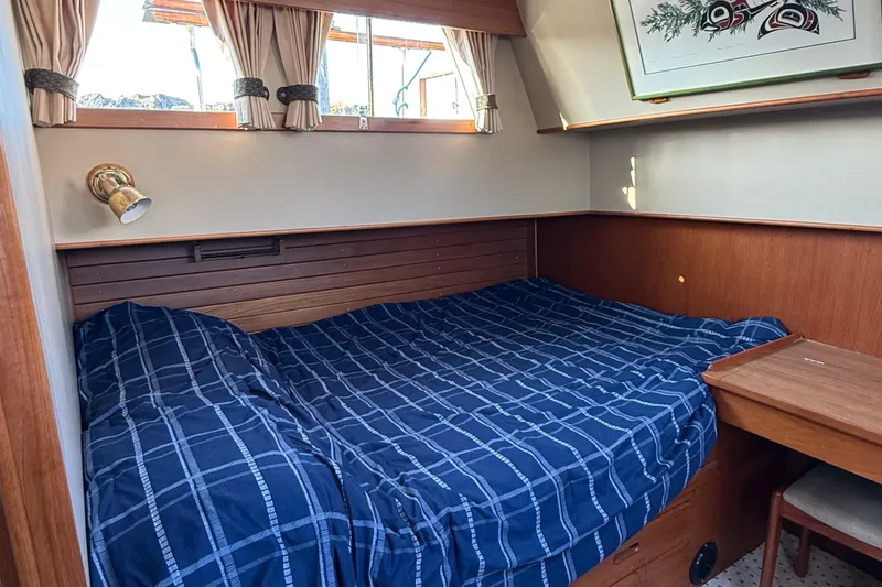 Slide: The Image of Cozy cabin interior of 1988 Grand Banks Heritage CL with blue plaid bedding. - 23