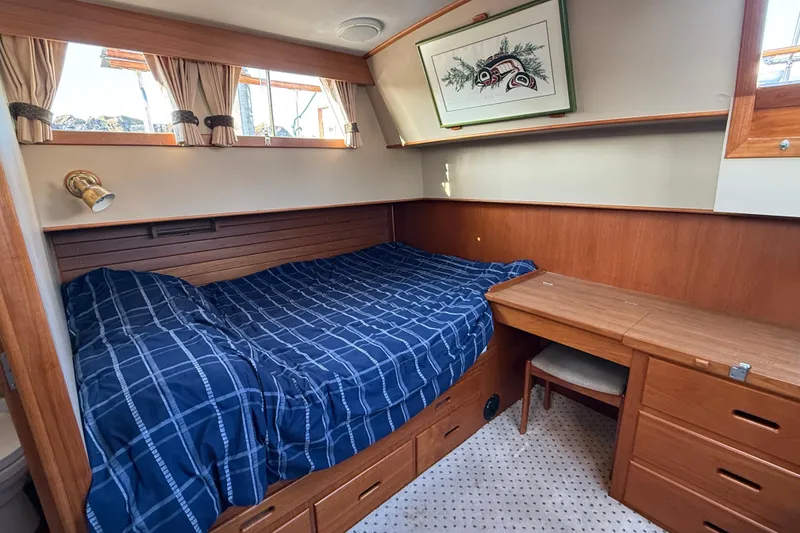 Slide: The Image of Cozy cabin interior of 1988 Grand Banks Heritage CL with bed and wooden desk. - 25