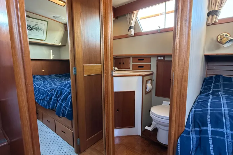Slide: The Image of 1988 Grand Banks Heritage CL interior with twin beds and compact bathroom. - 26