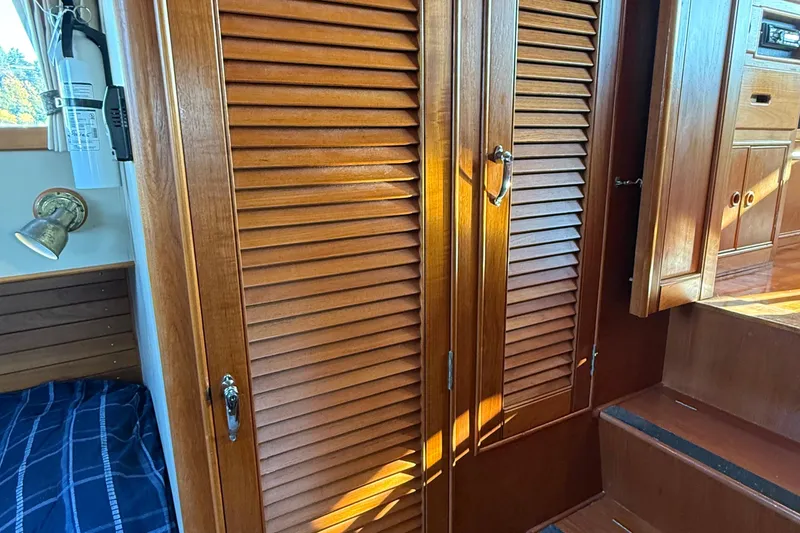 Slide: The Image of 1988 Grand Banks Heritage CL interior with wooden louvered doors and nautical decor. - 29