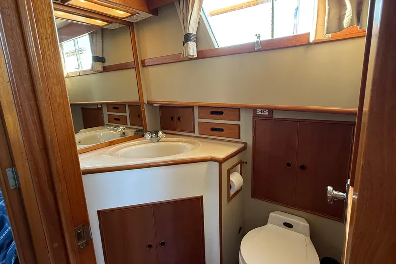 Slide: The Image of 1988 Grand Banks Heritage CL yacht bathroom with wooden cabinetry and sink. - 30