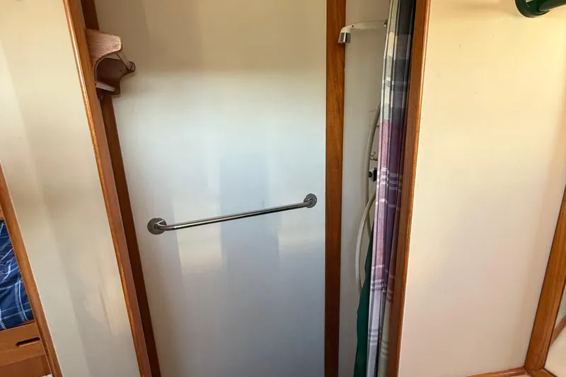Slide: The Image of Shower area inside 1988 Grand Banks Heritage CL boat with wooden trim. - 31