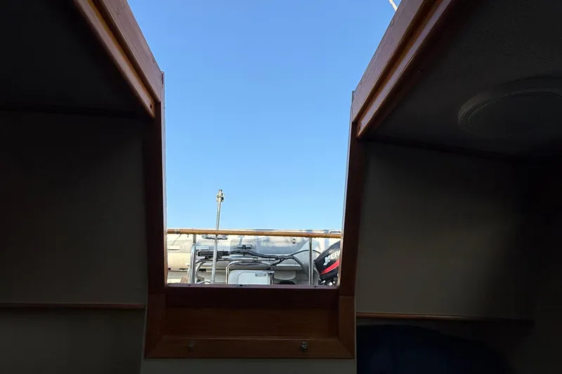 Slide: The Image of View from inside 1988 Grand Banks Heritage CL boat, looking out to clear blue sky. - 32