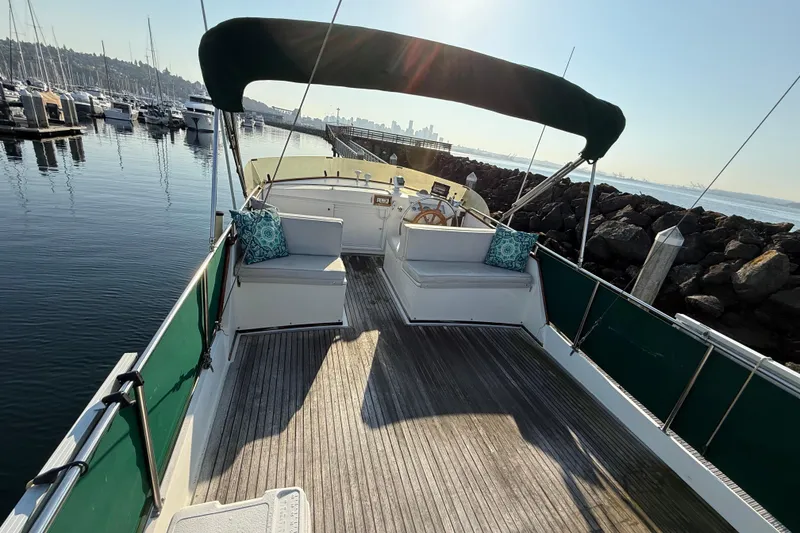 Slide: The Image of 1988 Grand Banks Heritage CL yacht with spacious deck and seating, docked at marina. - 41