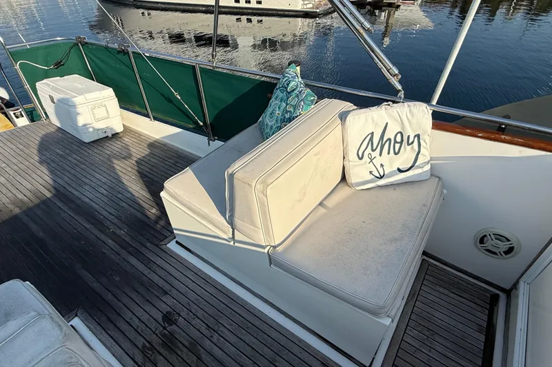 Slide: The Image of 1988 Grand Banks Heritage CL boat deck with seating, cushion, and "Ahoy" pillow. - 45