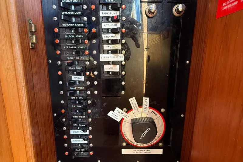 Slide: The Image of Control panel of a 1988 Grand Banks Heritage CL boat with labeled switches and dials. - 47