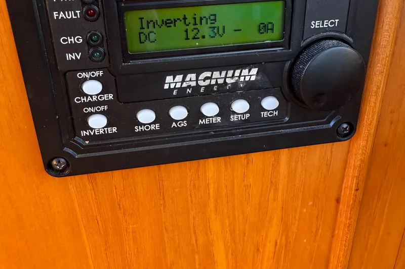 Slide: The Image of Control panel on 1988 Grand Banks Heritage CL boat, displaying Magnum Energy inverter settings. - 49