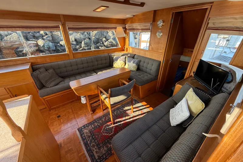 Slide: The Image of Luxurious 1988 Grand Banks Heritage CL yacht interior with cozy seating and elegant wood finishes. - 6