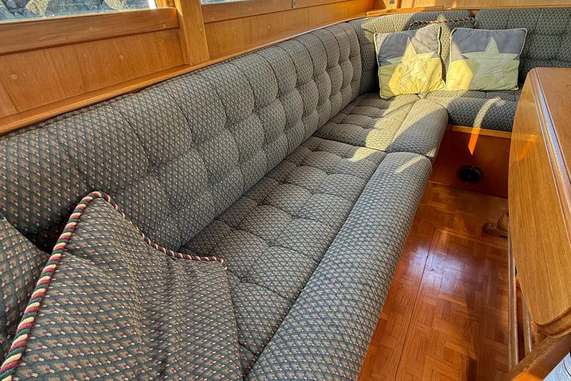 Slide: The Image of 1988 Grand Banks Heritage CL interior with patterned seating and star-themed cushions. - 7