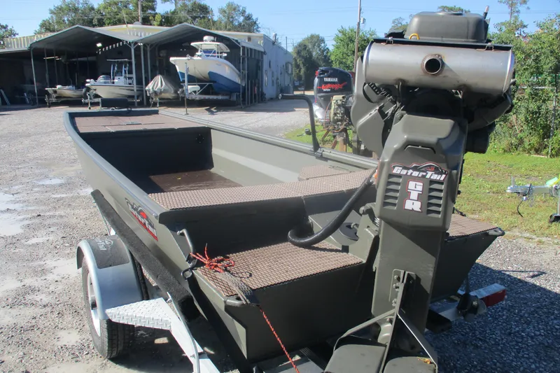 Slide: The Image of 2026 Gator Tail 1748 Gator Series boat on trailer, parked outdoors near other boats. - 3