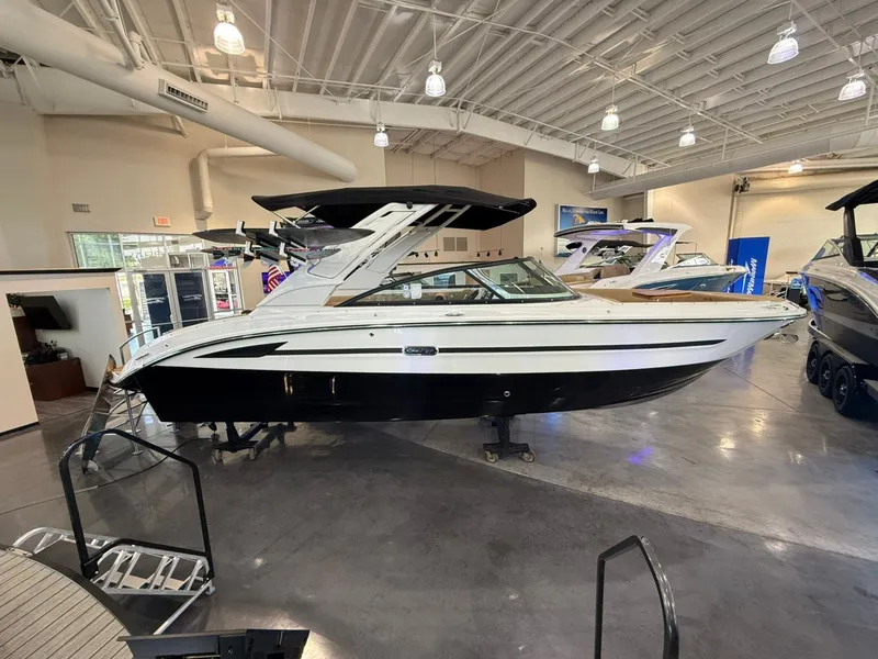Slide: The Image of 2026 Sea Ray SDX 270 Surf boat in a showroom. - 0