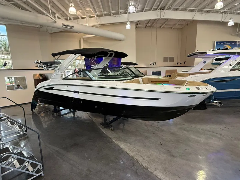 Slide: The Image of 2026 Sea Ray SDX 270 Surf boat in showroom. - 1