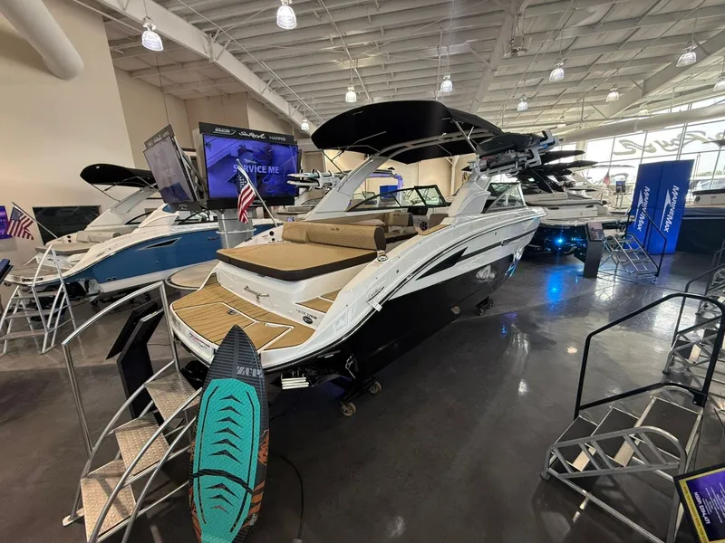 Slide: The Image of 2026 Sea Ray SDX 270 Surf boat in showroom. - 2
