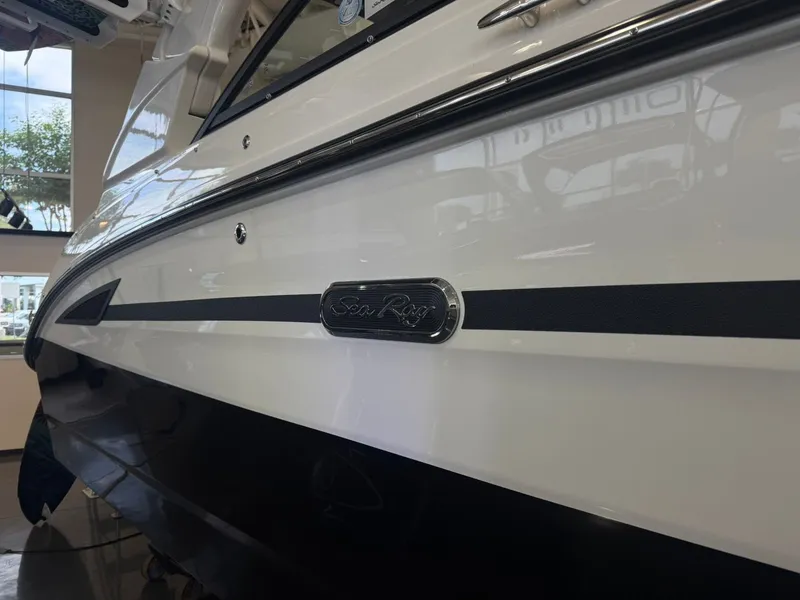 Slide: The Image of 2026 Sea Ray SDX 270 Surf boat in a showroom. - 3