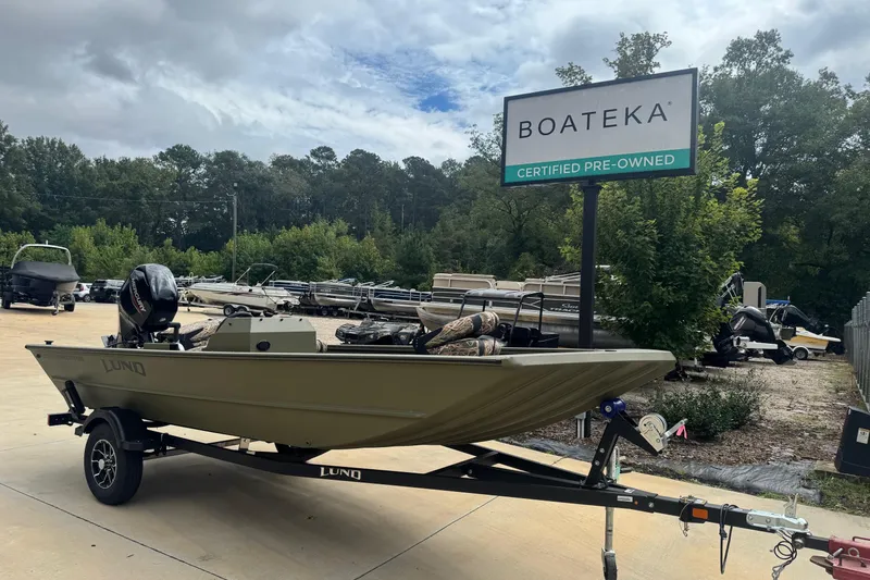 Slide: The Image of 2026 Lund 1760 Predator SC boat on trailer at Boateka certified pre-owned lot. - 1