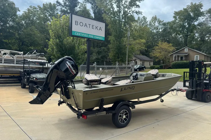 Slide: The Image of 2026 Lund 1760 Predator SC boat at Boateka dealership, certified pre-owned. - 2