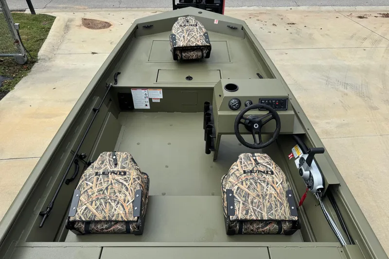 Slide: The Image of 2026 Lund 1760 Predator SC boat interior with storage compartment and camo seat. - 7