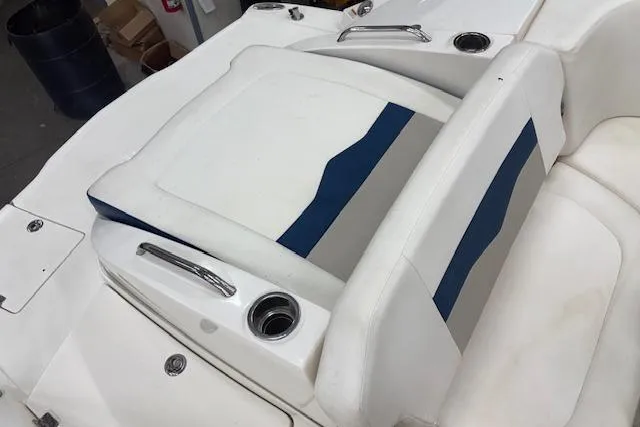 Slide: The Image of 2011 Chaparral 226 SSi boat interior with white and blue seating and stainless steel handles. - 10