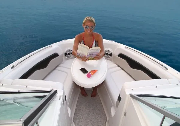 Slide: The Image of Manufacturer Provided Image: Woman reading on a 2011 Chaparral 226 SSi boat, enjoying the open water. - 17