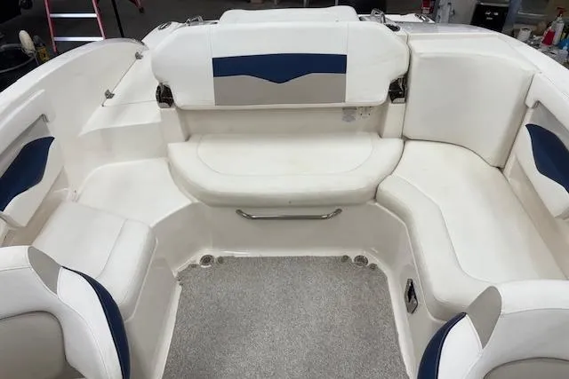 Slide: The Image of 2011 Chaparral 226 SSi boat interior with white and blue seating arrangement. - 6