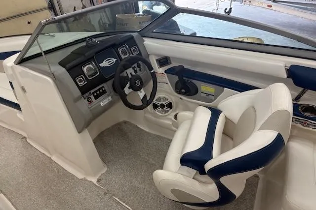 Slide: The Image of 2011 Chaparral 226 SSi boat interior with steering wheel and captain's chair. - 8