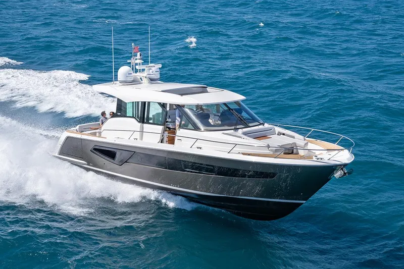 Slide: The Image of Manufacturer Provided Image: 2025 Tiara Yachts EX 54 cruising on open sea, showcasing sleek design and luxury. - 1