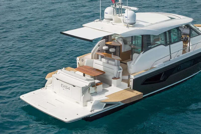 Slide: The Image of Manufacturer Provided Image: 2025 Tiara Yachts EX 54 luxury yacht on clear blue water. - 4