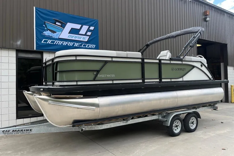 The Image of 2026 Godfrey Sweetwater 2086 SB pontoon boat on trailer outside CIC Marine. - 0