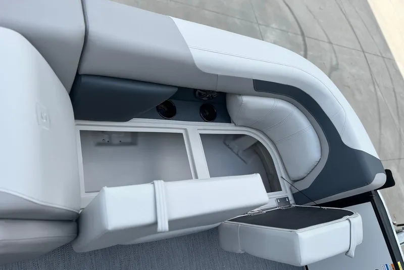 Slide: The Image of 2026 Godfrey Sweetwater 2086 SB boat interior with white cushioned seating and storage compartment. - 14