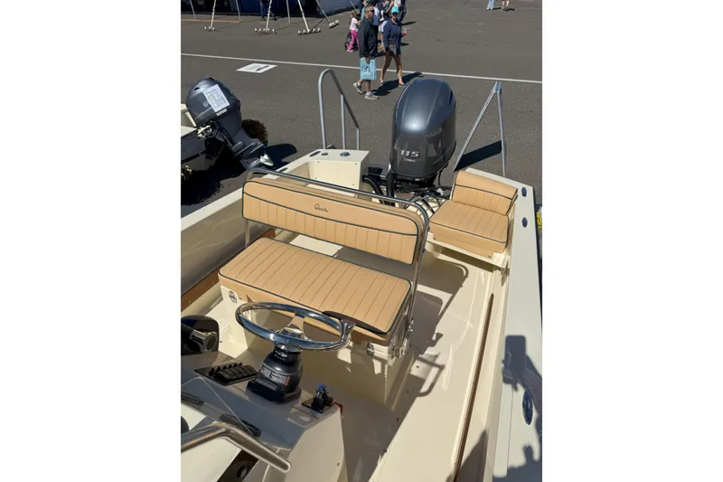 Slide: The Image of 2026 Rossiter 17 CC boat interior with tan seating and Yamaha 115 engine. - 11