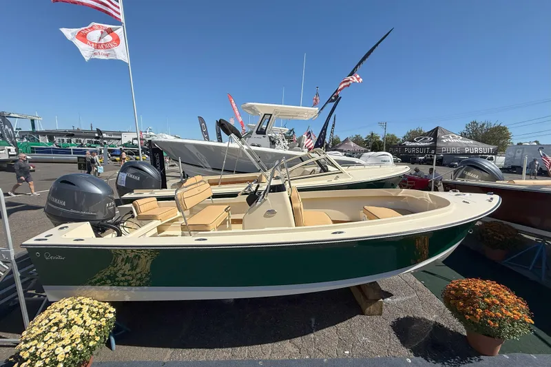 Slide: The Image of 2026 Rossiter 17 CC boat displayed at an outdoor boat show with Yamaha engines. - 2