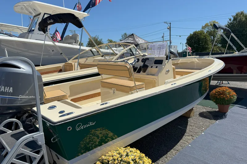 Slide: The Image of 2026 Rossiter 17 CC boat displayed outdoors with Yamaha engine and floral decor. - 5