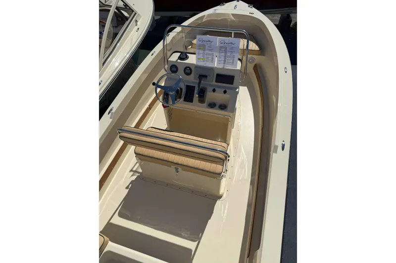 Slide: The Image of 2026 Rossiter 17 CC boat interior with steering console and seating. - 6